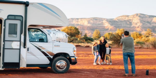 Family taking picture outside RV